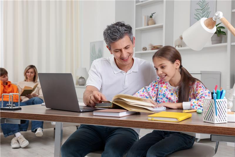 Teenager learning online with teacher support during homeschooling.